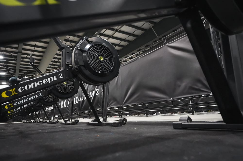 Rowing machines lined up at a race venue